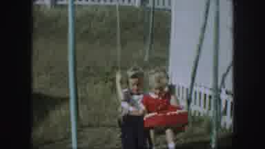 Kansas City Missouri (1959): A Young Boy And Girl Swinging On A Playset With