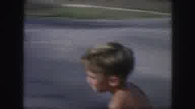 Kansas City Missouri (1959): Kid Rides Bicycle Down Suburban Street Passes By Stop