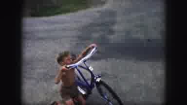 Kansas City Missouri (1959): Child Falls From Blue Bicycle While Woman Wearing