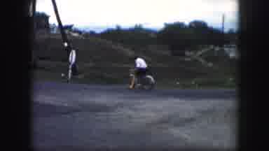 Kansas City Missouri (1959): Woman Riding A Bicycle Down The Middle Of The Street