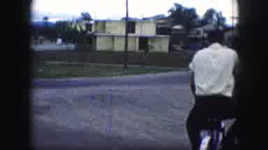 Kansas City Missouri (1959): Young Man And Woman Ride Bikes Together While The
