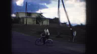 Kansas City Missouri (1959): A Man Riding A Bike Outside Having Fun With Houses In