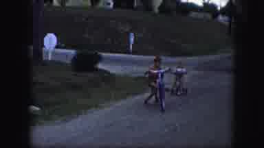 Kansas City Missouri (1959): Young Boys Riding Bikes And Playing In The Street On