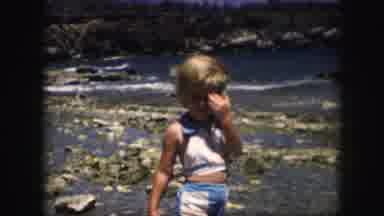 Kansas City Missouri (1959): Vintage Film Clip Of A Child On A Rocky Beach Rubbing