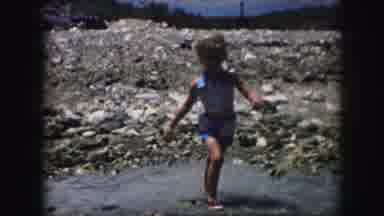 Kansas City Missouri (1959): Child Balancing During A Few Steps Through Puddle