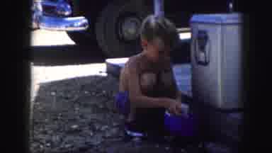 Kansas City Missouri (1959): Boy Squatting Putting Something Away Family Softball