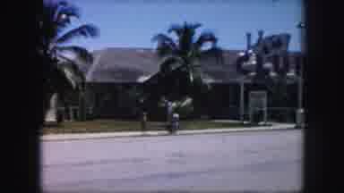 Kansas City Missouri (1959): A Parent With Two Kids Walking Down The Street Near