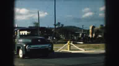 Kansas City Missouri (1959): Two Workers Riding Down The Street From A Small