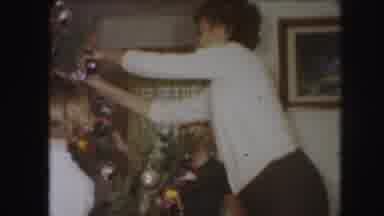 KANSAS CITY MISSOURI-1959: Mother Decorates Christmas Tree With Two Young Children