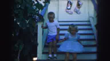 Kansas City Missouri (1959): Two Young Blonde Children Are Hopping Down A Wooden