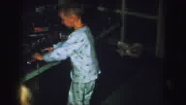 Kansas City Missouri (1959): Two Children Wearing Pajamas Playing With A Model