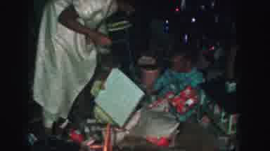 Kansas City Missouri (1959): Two Children Excitedly Opening Presents With Their