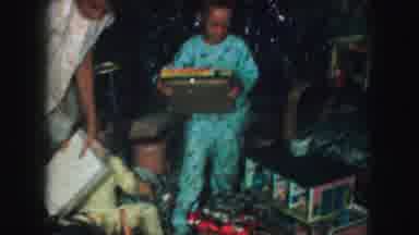 Kansas City Missouri (1959): Young Kids In Pajamas Happily Unwrapping Gifts On