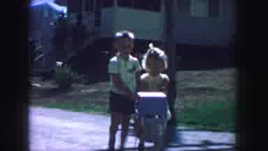 Kansas City Missouri (1959): Boy And Girl In Similar Yellow Patterned Outfits Push