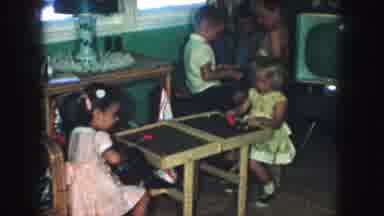 Kansas City Missouri (1959): Children Playing With Toy Tools In A Family Room
