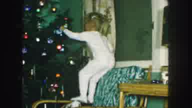Kansas City Missouri (1959): Young Children In Pajamas Put Up Ornaments While