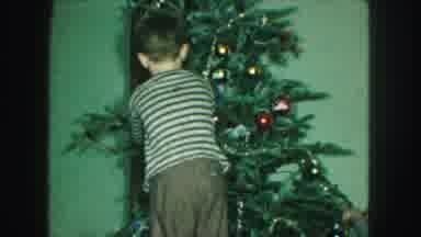 KANSAS CITY MISSOURI-1959: Young Boy Decorating Christmas Tree