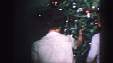 Kansas City Missouri (1959): A Woman Is Setting A Christmas Tree Up And Then