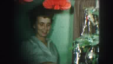 Kansas City Missouri (1959): A Lady With Brown Hair Decorating A Christmas Tree