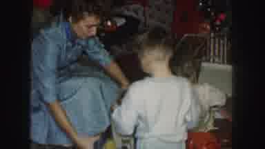 Kansas City Missouri (1959): Two Young Children In Pajamas Unwrapping Gifts On