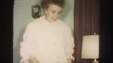 Kansas City Missouri (1959): Woman In Pink Robe Gathering Holiday Gift Wrap While
