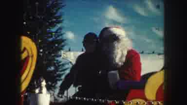 Kansas City Missouri (1959): A Boy Sits With Santa Clause While Sitting In His