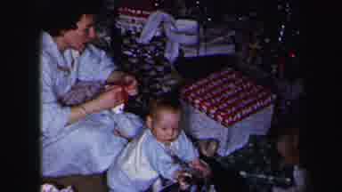 Lynbrook New York (1975): Mother With Children Opening Wrapped Christmas Presents