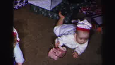Lynbrook New York (1975): Two Baby With Christmas Hat Crawling Next To Phone Toys
