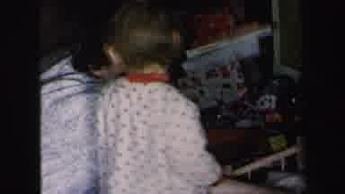 Lynbrook New York-1975: Mother Comforts Crying Child During Christmas Morning