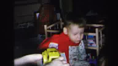 Lynbrook New York (1975): A Toddler And A Baby Offered A Yellow Toy Truck By A