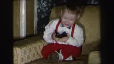 Lynbrook New York (1975): Reel Film Of A Baby With A Bow Tie Sitting On A Couch