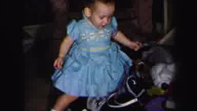 Lynbrook New York (1975): Toddler Girl In Blue Dress Sits Down On Black Rocking