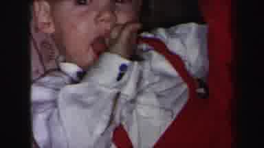Lynbrook New York (1975): A Person Filming A Baby With His Hand In His Mouth And