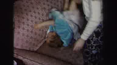 Lynbrook New York (1975): A Child Being Played With By Their Parent On A Couch