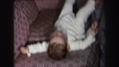 Lynbrook New York (1975): Dad Picks Up Baby In White Pajamas And Bounces Him On