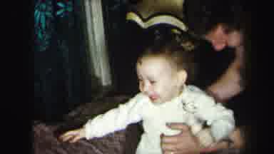 Lynbrook New York (1975): Father Bounces Happy Laughing Baby On A Very Springy