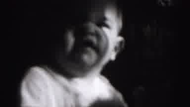 Harrisburg Pennsylvania USA (1975): This Scary Baby In A Dark Room Grimaces And