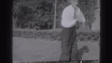 Harrisburg Pennsylvania USA (1975): A Man In A Tie Swings Vigorously Swings A Golf