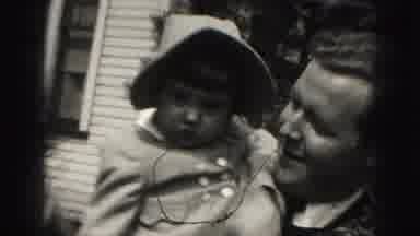 Harrisburg Pennsylvania USA (1975): Woman And Man Take Turns Holding Baby In Front