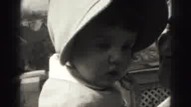 Harrisburg Pennsylvania USA (1975): Baby In A Coat And A Hat With A Man On A Porch