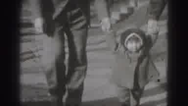Harrisburg Pennsylvania USA-1975: Mother And Father Hold Baby Girl's Hands And Help Her Walk
