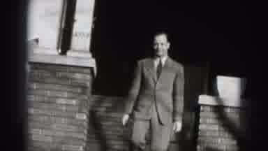 Harrisburg Pennsylvania USA (1975): A Man Is Coming Out From The Building With A