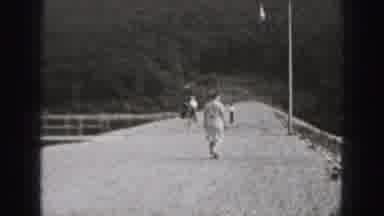 HARRISBURG PENNSYLVANIA USA-1975: People Walk Near Stone Building By Water