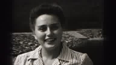 Harrisburg Pennsylvania USA (1975): Small Black Dog Walking To Woman Wiping Nose