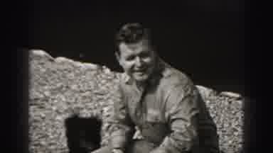 Harrisburg Pennsylvania USA (1975): Man Watches And Pets Small Frisky Black Puppy