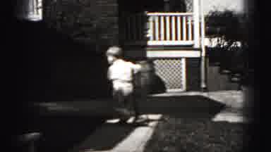 Harrisburg Pennsylvania USA (1975): Young Boy Riding A Scooter Along A Sidewalk