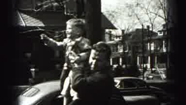 Harrisburg Pennsylvania USA (1975): Man Holds Up Son On His Shoulder To Help Him