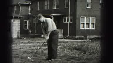 Harrisburg Pennsylvania USA (1975): A Man Is Playing Golf In Outside Of The House