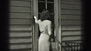 Harrisburg Pennsylvania USA (1975): Woman Comes Outside Closes The Door And Points