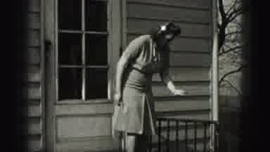 Harrisburg Pennsylvania USA (1975): Woman Turns And Sits On The Porch Frame And